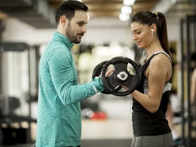 young-woman-with-personal-trainer-in-gym-2023-11-27-05-09-09-utc (2)